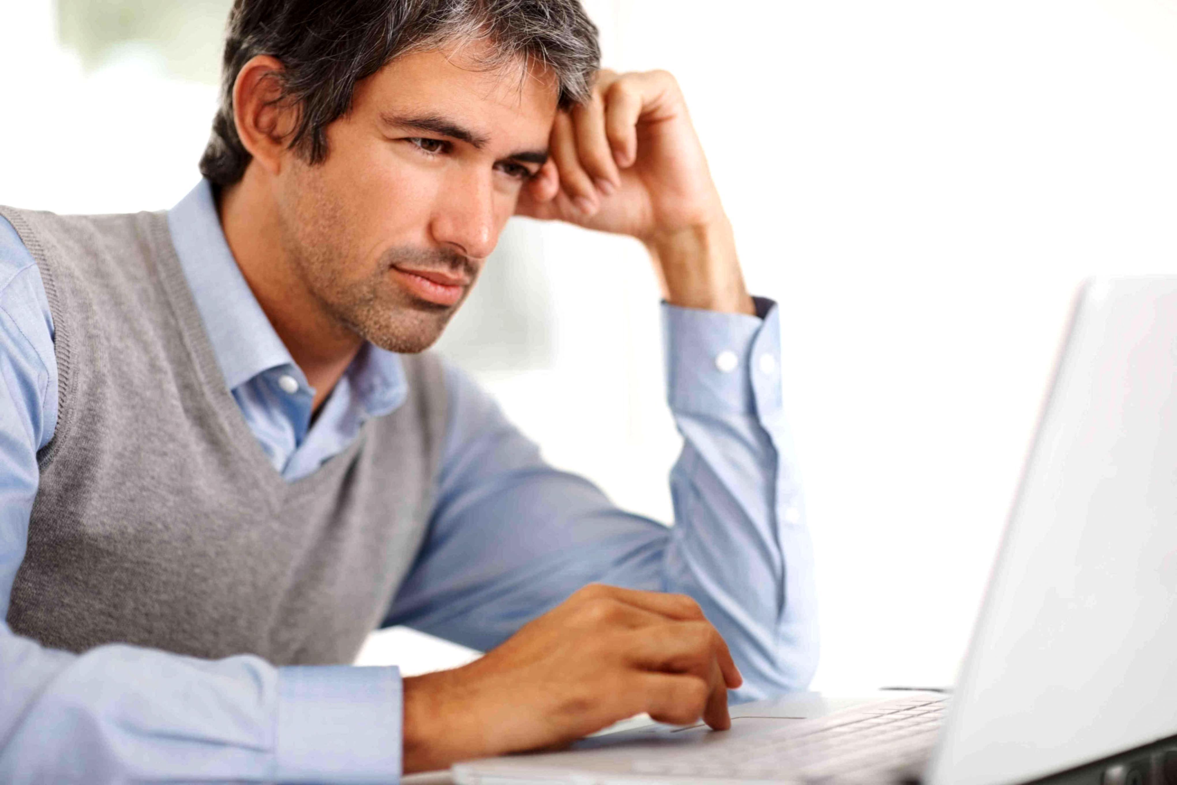 Person reviewing financial documents with focused attention